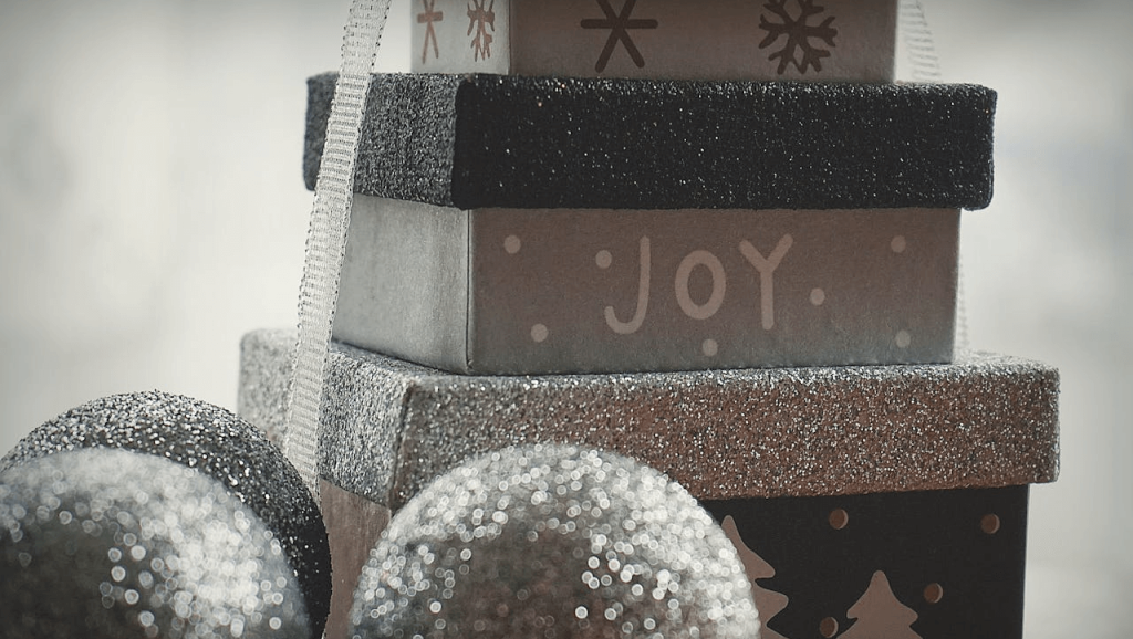 christmas present stacked on top of each other with the word joy illustrating the multiple hotel promotion strategies that could be adopted to boost group sales and revenue