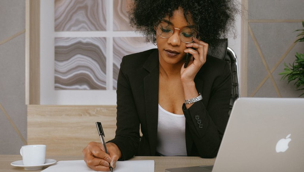 lady on the phone reflecting the importance to hotels of auccessful outbound sales strategies for the voice channel