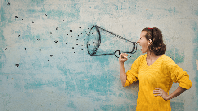 person shouting through a loud hailer reflecting the importance to focus on share of voice and prioritize direct bookings