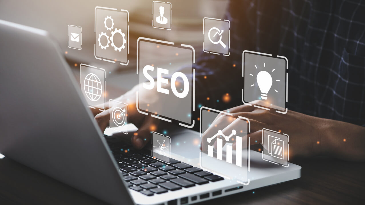 person on a laptop with marketing icons reflecting ai impact and vibe marketing