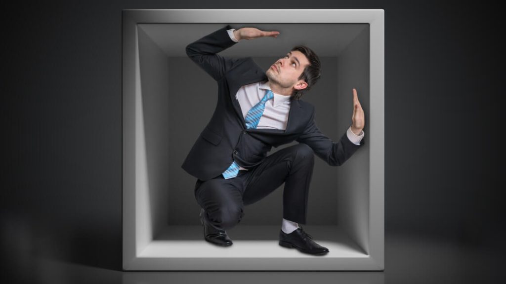 person trapped in a box similar to hoteliers when adopting an outdated approach to room pricing and strategy
