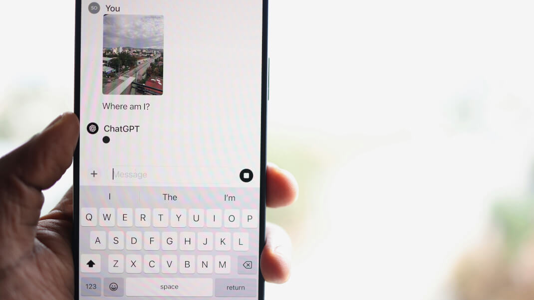 person on mobile using chatgpt to find out where they are maybe looking to book a stay illustrating the importance of hotel visibility on ai search platforms
