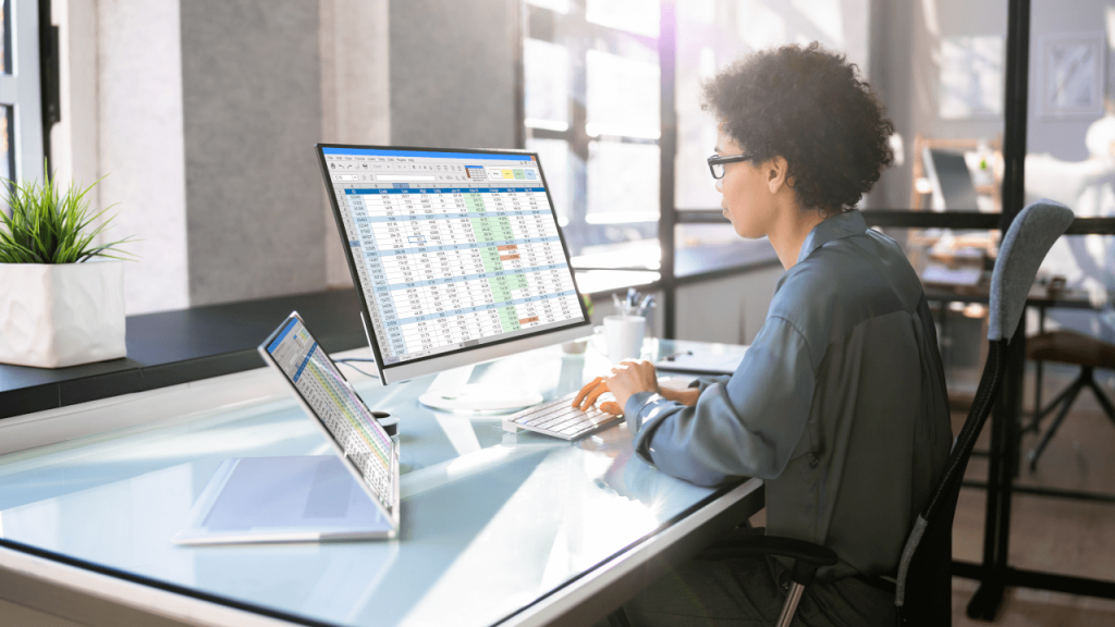 person looking at spreadsheets illustrating how valuable guest insights can be to developing an actionable revenue strategy