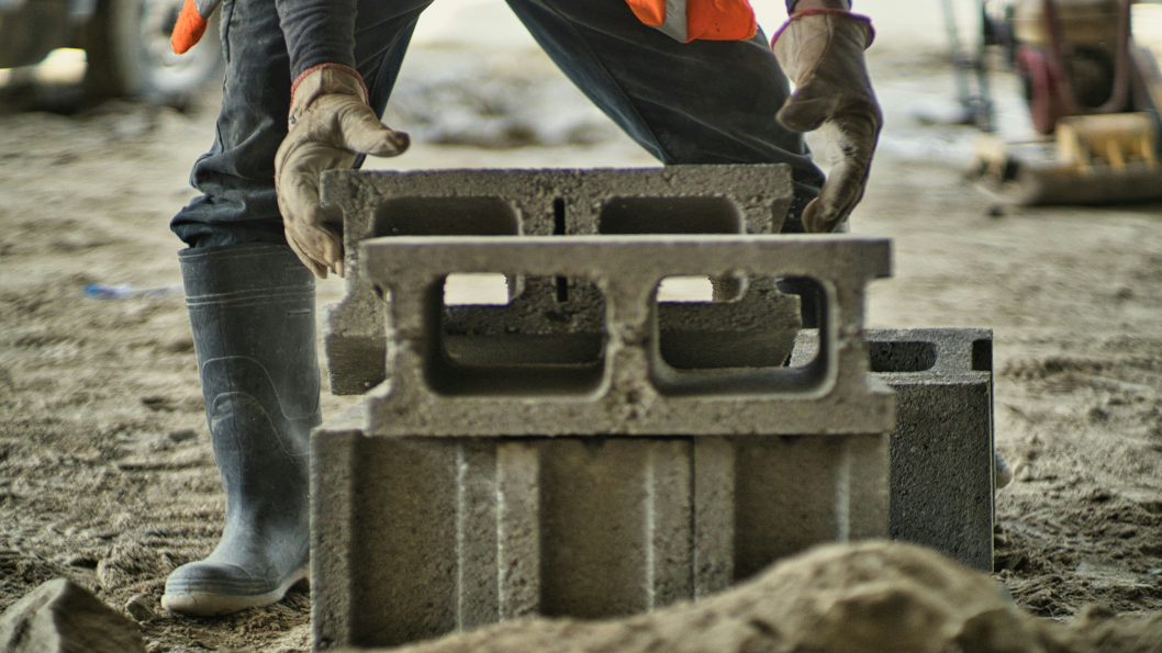 person laying foundation blocks in the same way hotels need to build foundations for their best revenue year yet
